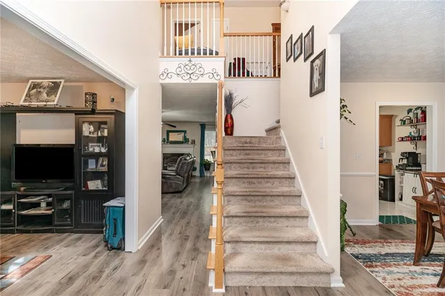a view of entryway and hall with wooden floor