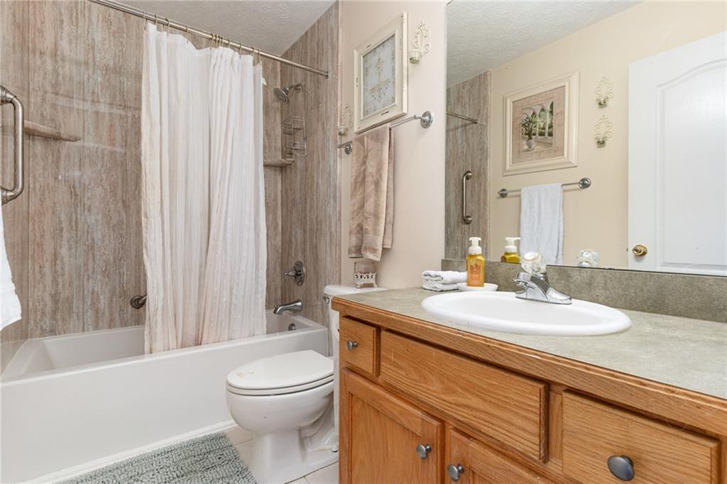 40 Cindy Circle Covington, GA 30016 - Photo 32 of 34 a bathroom with a sink a toilet and shower