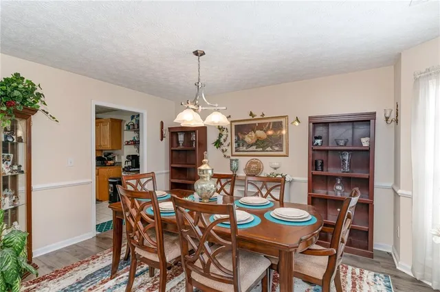 a view of a dining room with furniture and chandelier