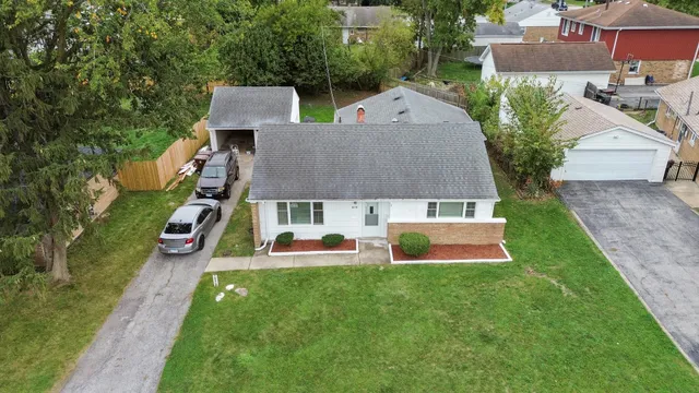 an aerial view of a house with swimming pool and a yard