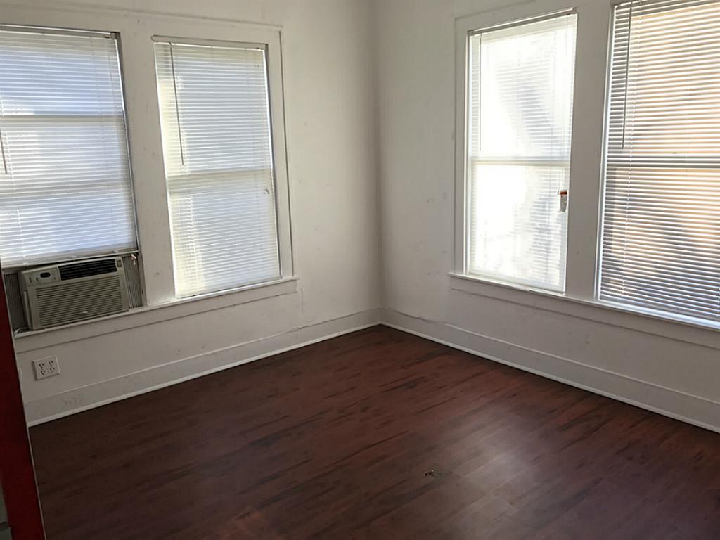 531 Threlkeld Street Houston, TX 77007 - Photo 11 of 15 an empty room with wooden floor and windows