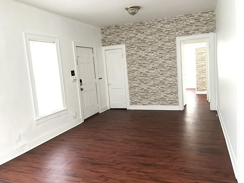 531 Threlkeld Street Houston, TX 77007 - Photo 6 of 15 an empty room with wooden floor and windows