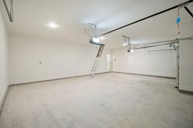 en empty room with ceiling fan and windows