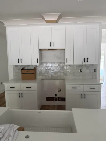 a kitchen with stainless steel appliances kitchen island sink stove and cabinets