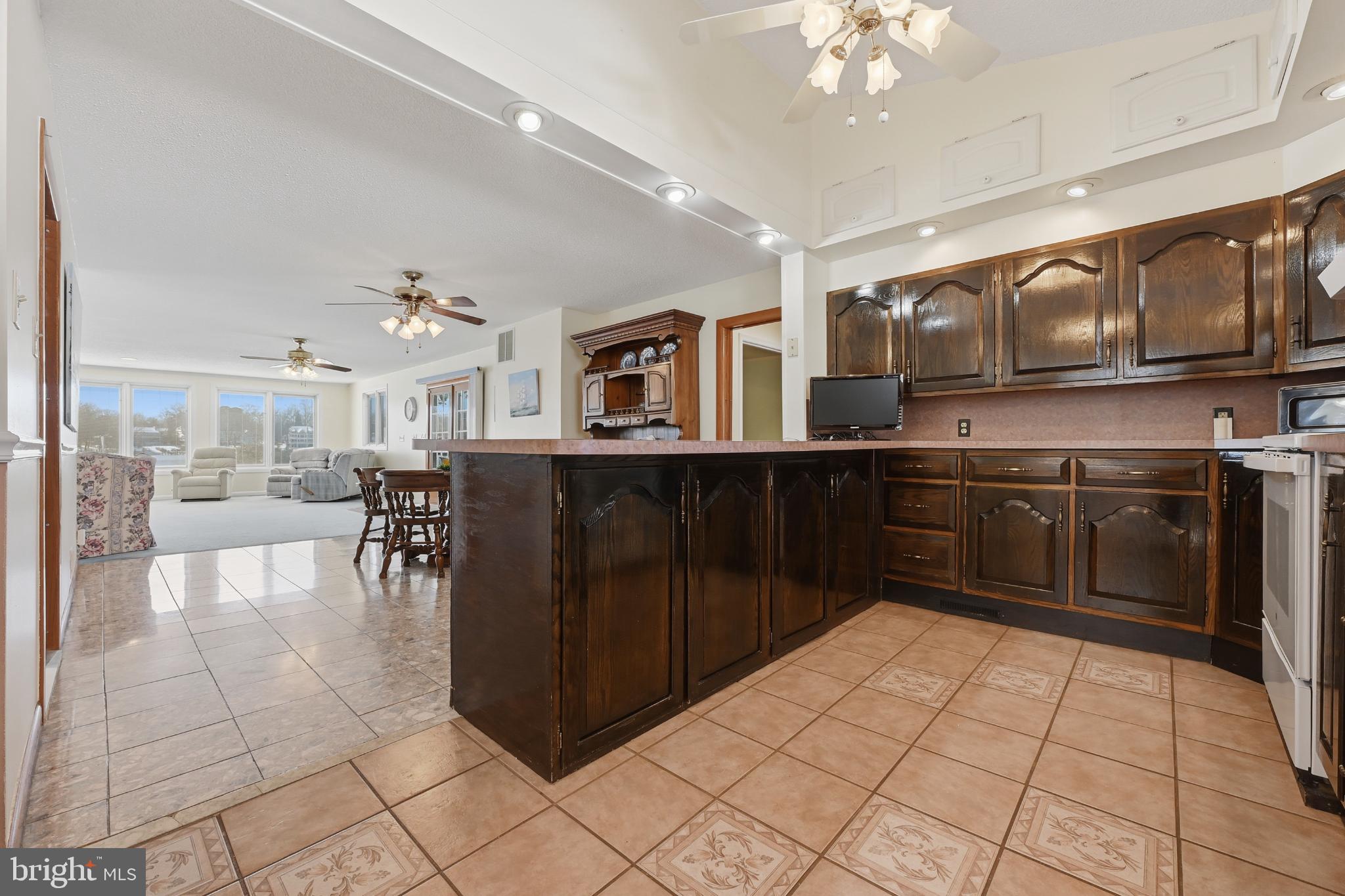352 Riverside Drive Pasadena, MD 21122 - Photo 12 of 48 a kitchen with stainless steel appliances granite countertop a refrigerator and a stove top oven