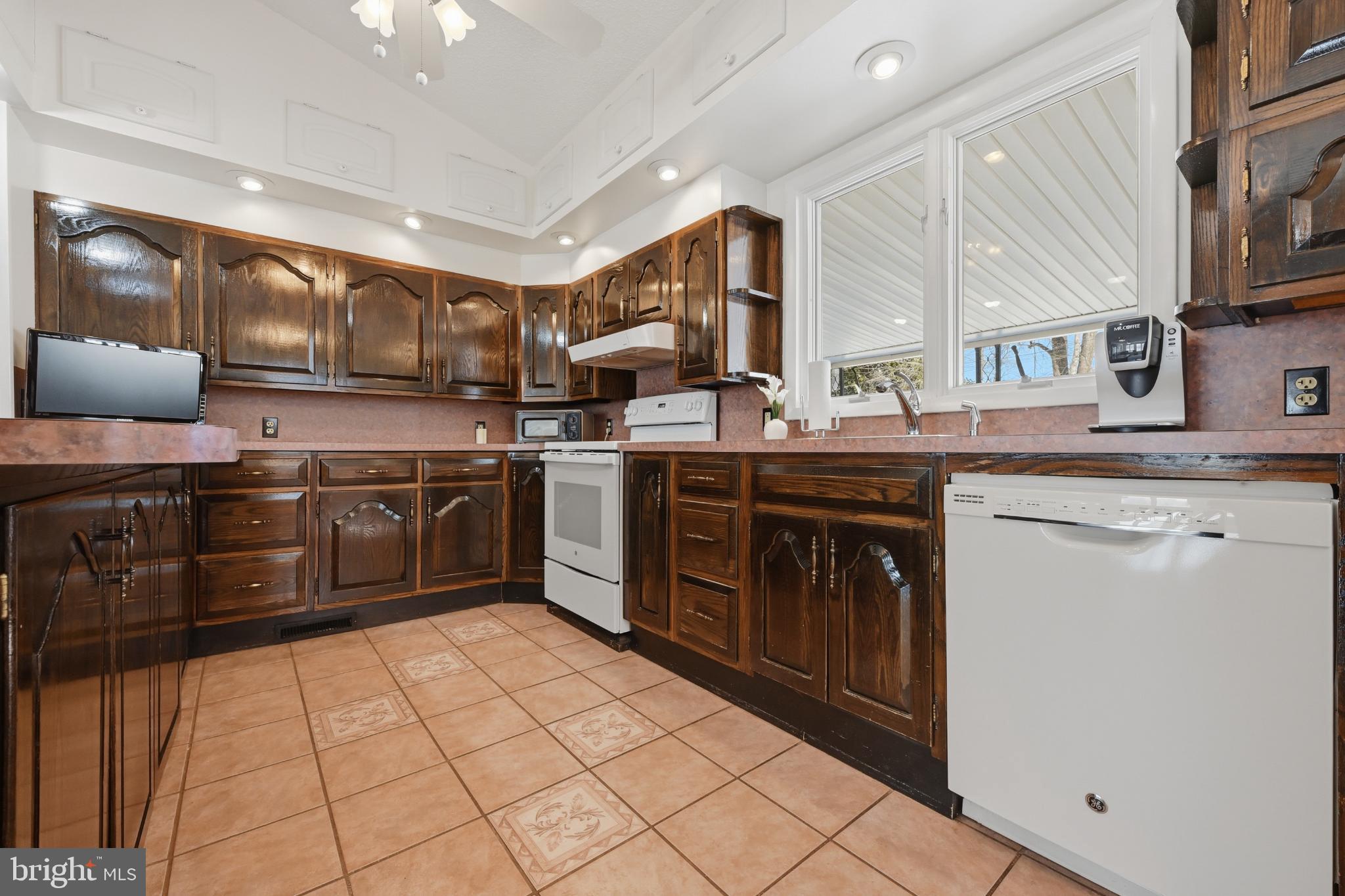 352 Riverside Drive Pasadena, MD 21122 - Photo 13 of 48 a kitchen with stainless steel appliances granite countertop a stove a sink and a microwave
