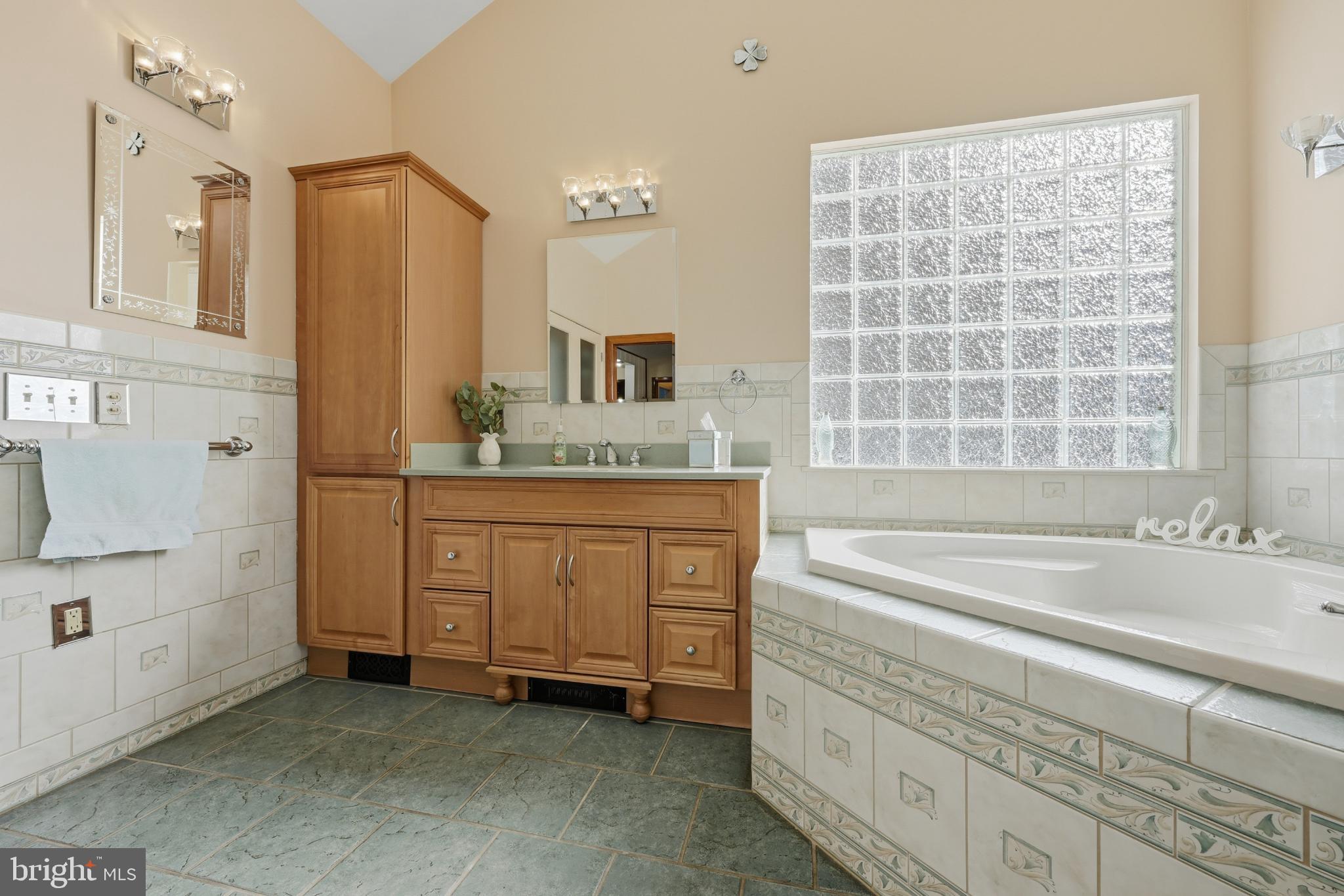 352 Riverside Drive Pasadena, MD 21122 - Photo 16 of 48 a bathroom with a granite countertop sink and a bathtub