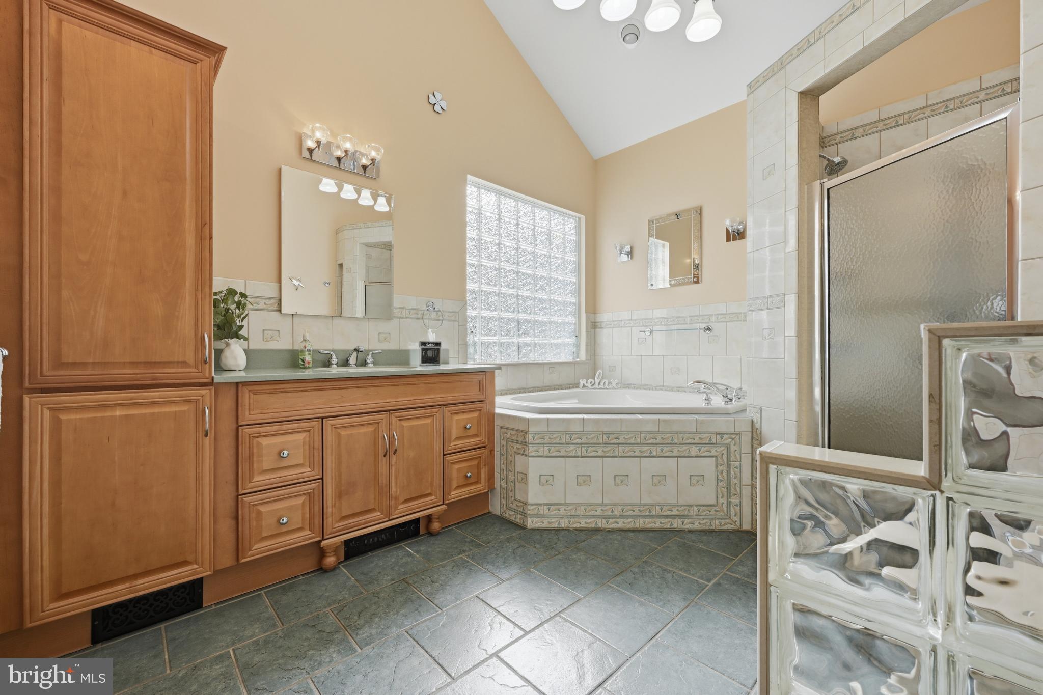 352 Riverside Drive Pasadena, MD 21122 - Photo 17 of 48 a bathroom with a granite countertop double vanity sink a mirror and a bathtub