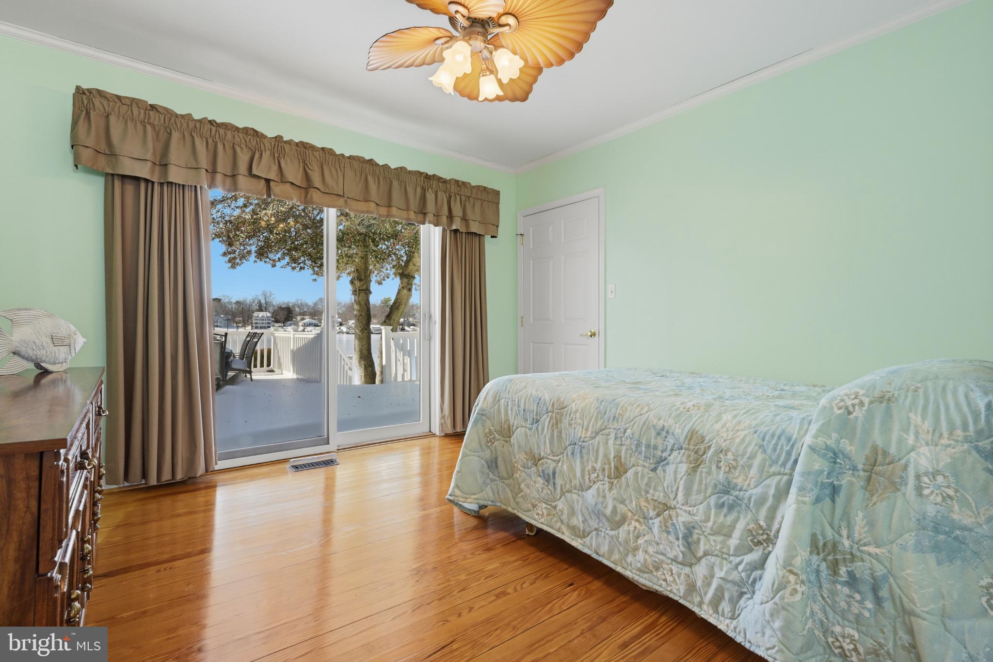 352 Riverside Drive Pasadena, MD 21122 - Photo 19 of 48 a bedroom with a bed and a large window with outer view