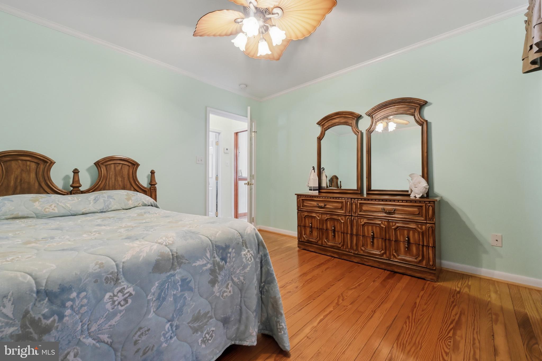 352 Riverside Drive Pasadena, MD 21122 - Photo 20 of 48 a bedroom with a bed and a chandelier