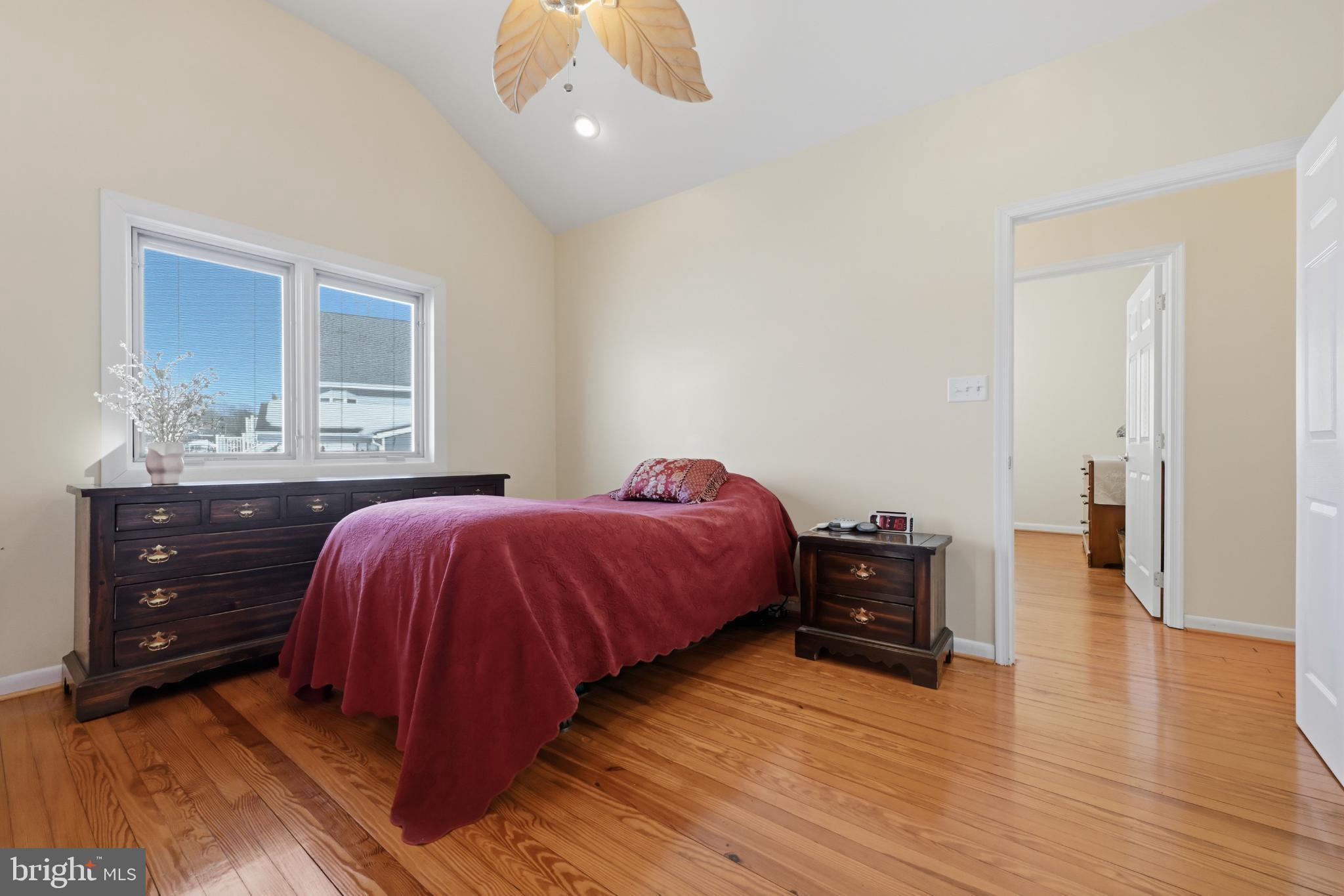 352 Riverside Drive Pasadena, MD 21122 - Photo 22 of 48 a spacious bedroom with a bed and wooden floor