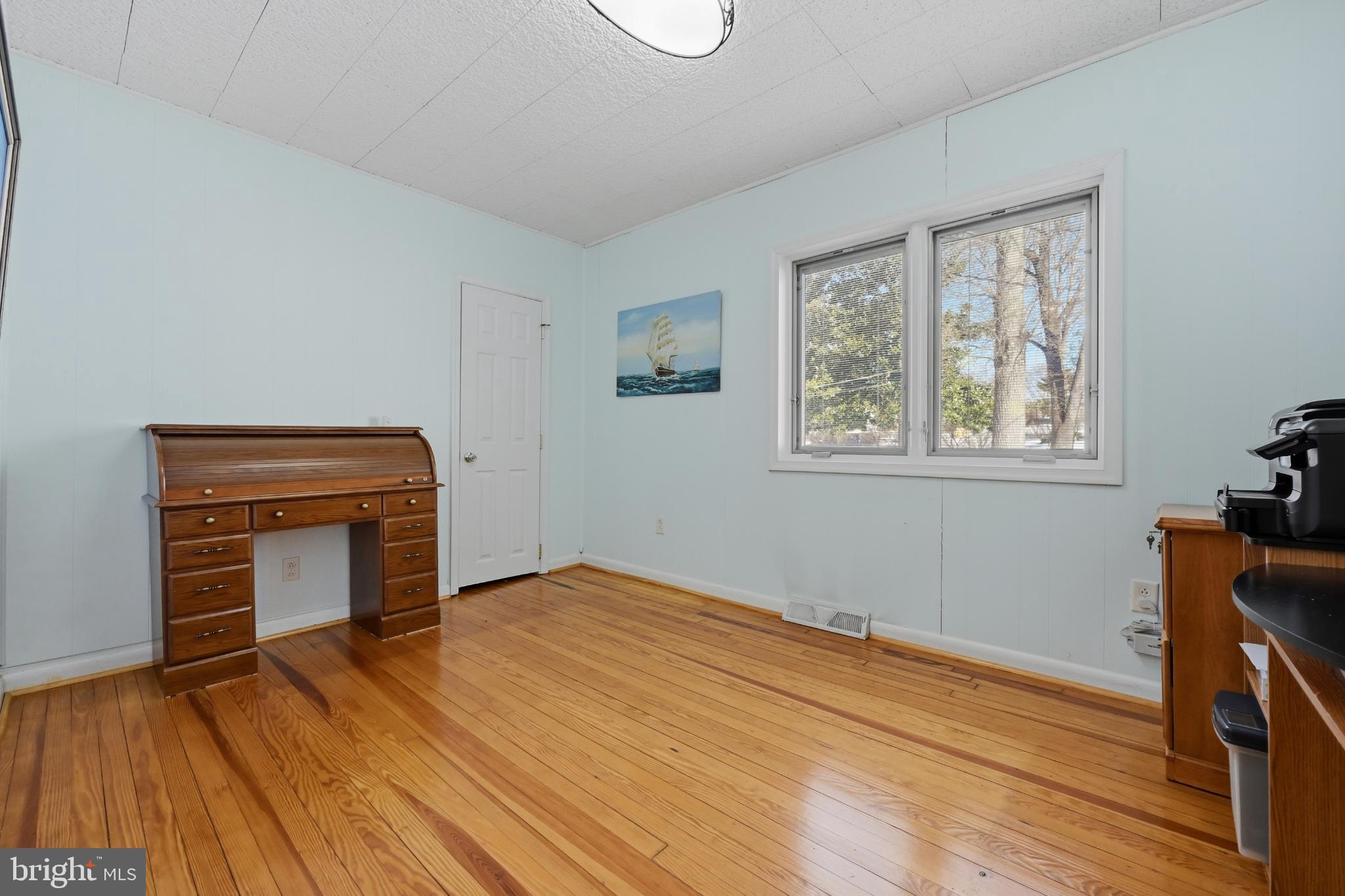 352 Riverside Drive Pasadena, MD 21122 - Photo 25 of 48 a view of empty room with wooden floor and fan
