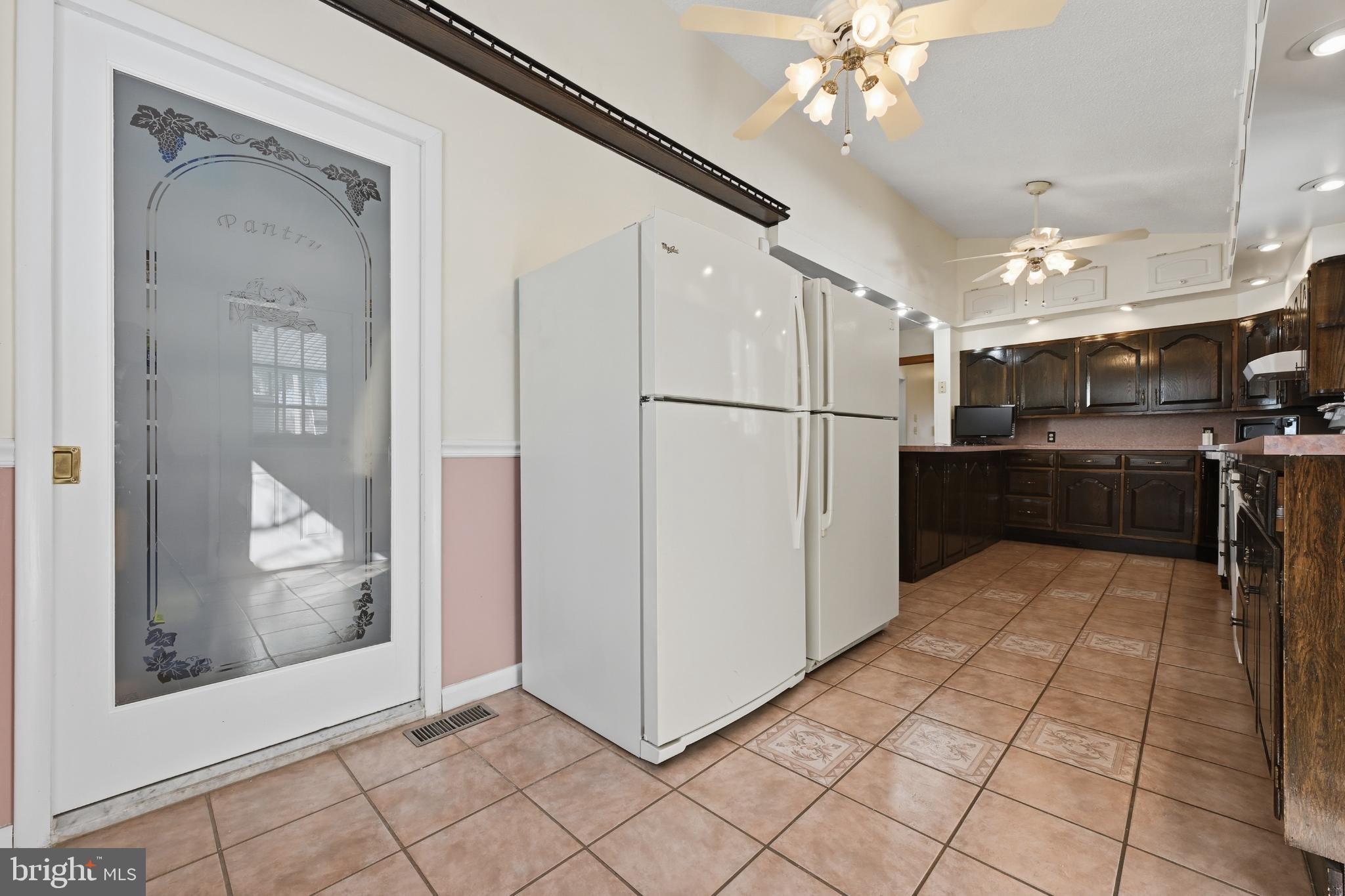 352 Riverside Drive Pasadena, MD 21122 - Photo 28 of 48 a kitchen with stainless steel appliances a refrigerator and a microwave