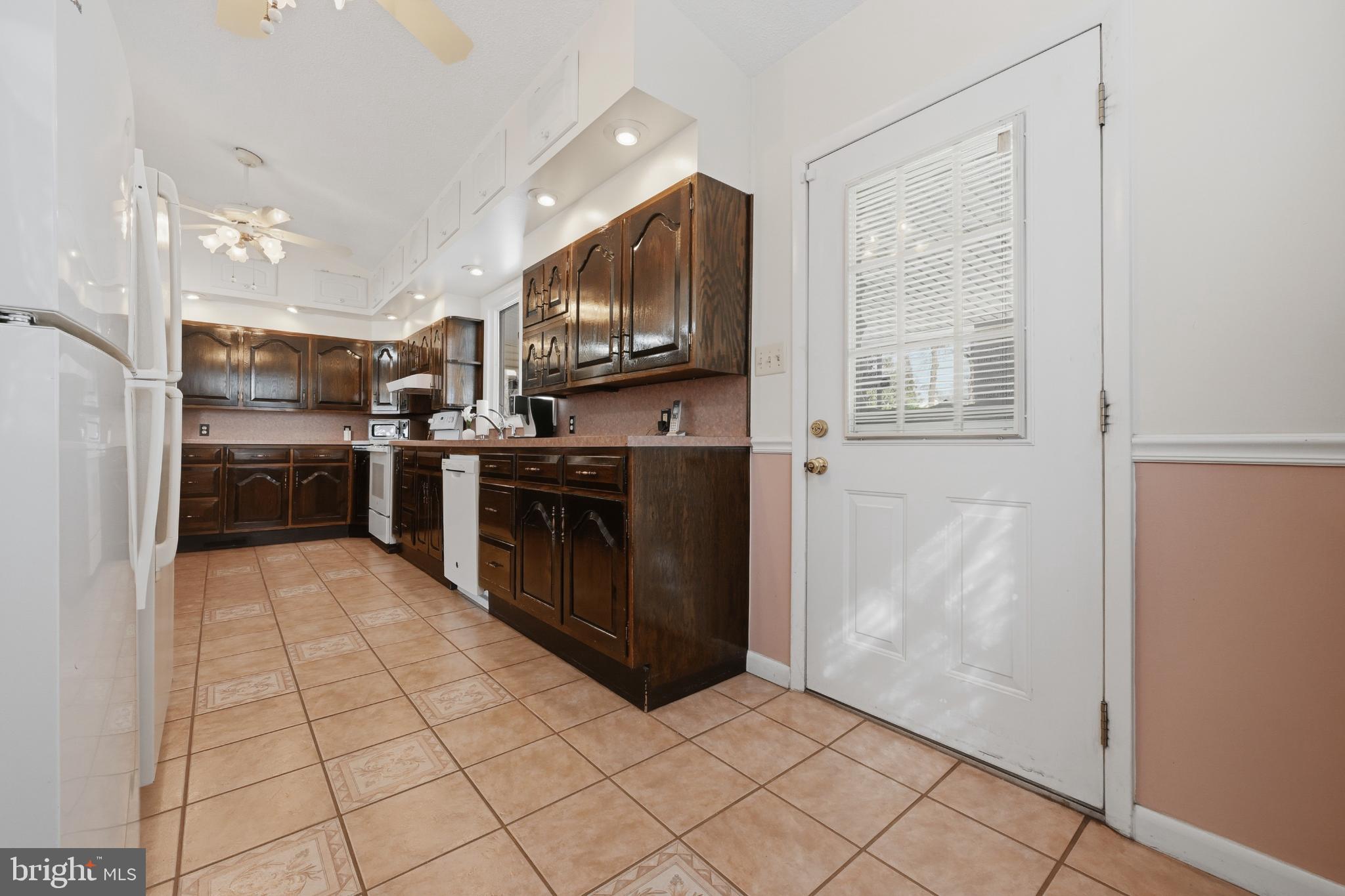 352 Riverside Drive Pasadena, MD 21122 - Photo 30 of 48 a kitchen with stainless steel appliances granite countertop a refrigerator and a stove top oven