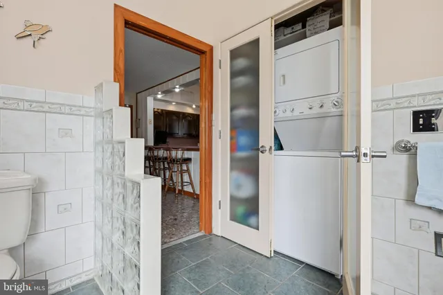a view of a chairs on wooden deck and lake