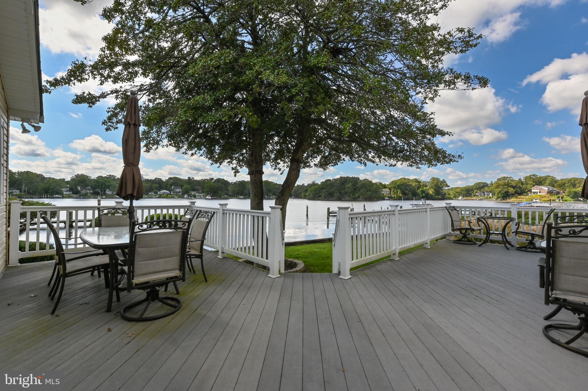352 Riverside Drive Pasadena, MD 21122 - Photo 32 of 48 a view of a chairs on wooden deck and lake