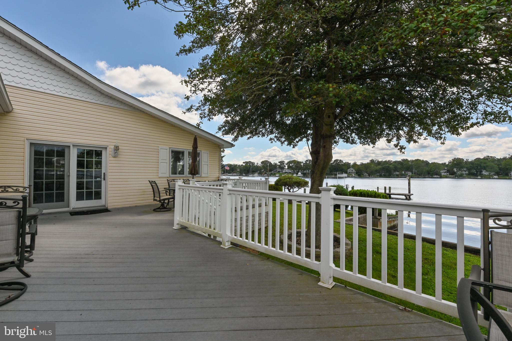 352 Riverside Drive Pasadena, MD 21122 - Photo 37 of 48 a view of a deck with a floor to ceiling window and a tree