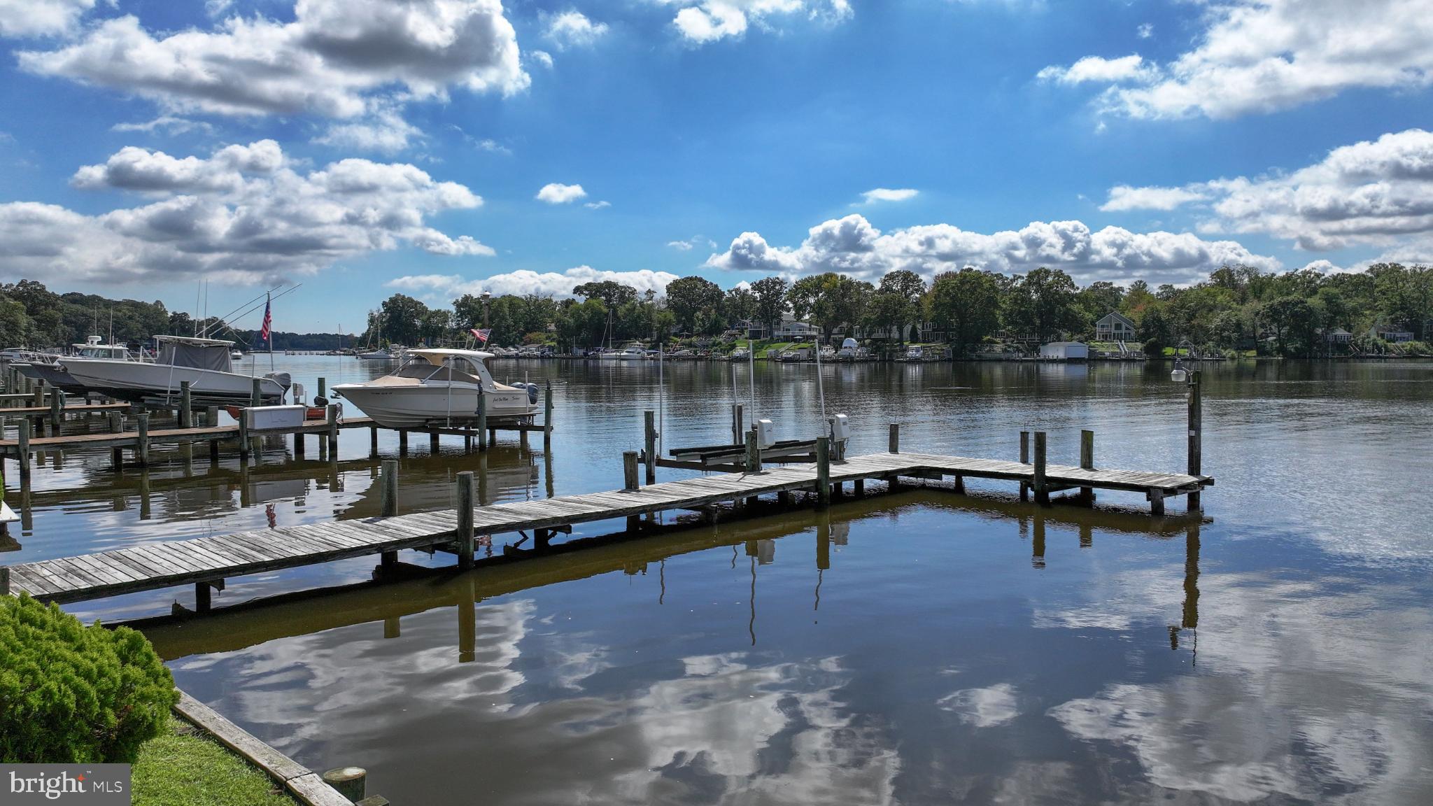 352 Riverside Drive Pasadena, MD 21122 - Photo 4 of 48 a view of a lake with chairs