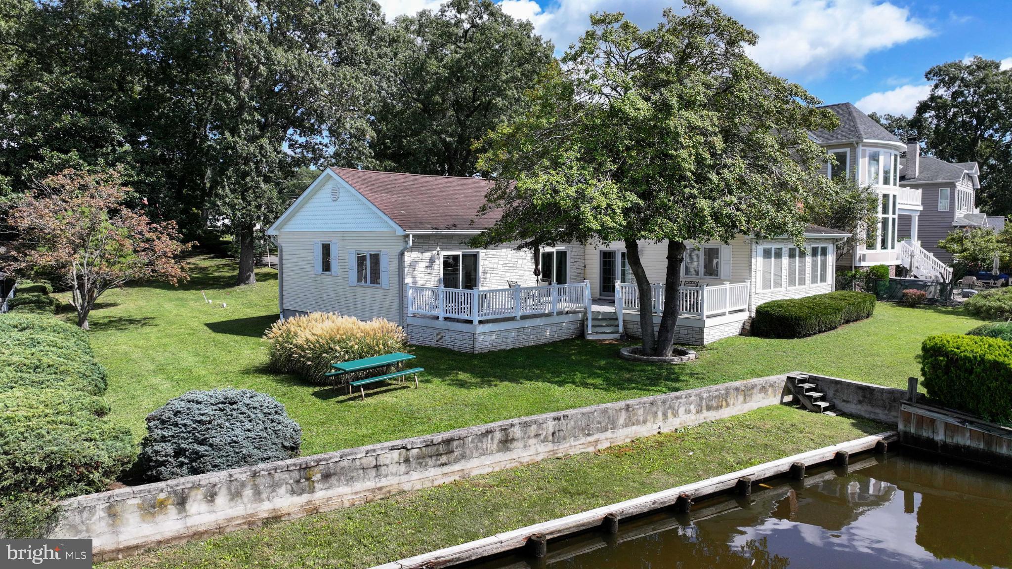 352 Riverside Drive Pasadena, MD 21122 - Photo 46 of 48 a view of a house with a backyard and a patio