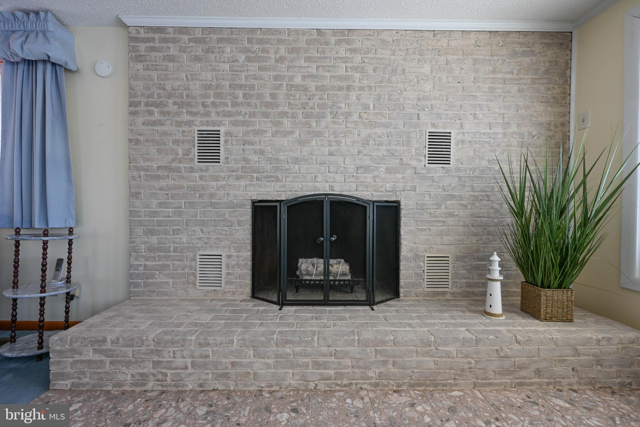 352 Riverside Drive Pasadena, MD 21122 - Photo 8 of 48 a living room with a fireplace
