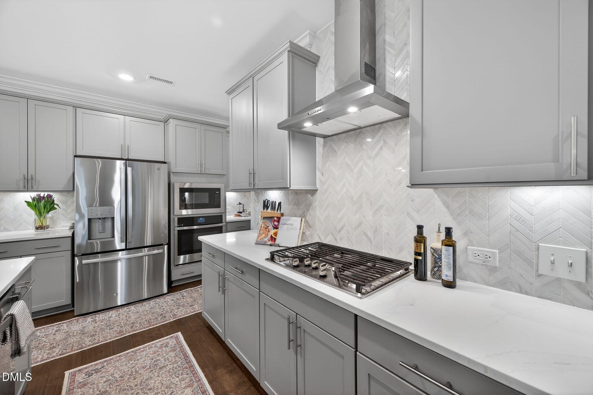 100 English Violet Lane Raleigh, NC 27610 - Photo 16 of 101 a kitchen with stainless steel appliances granite countertop a sink stove and refrigerator