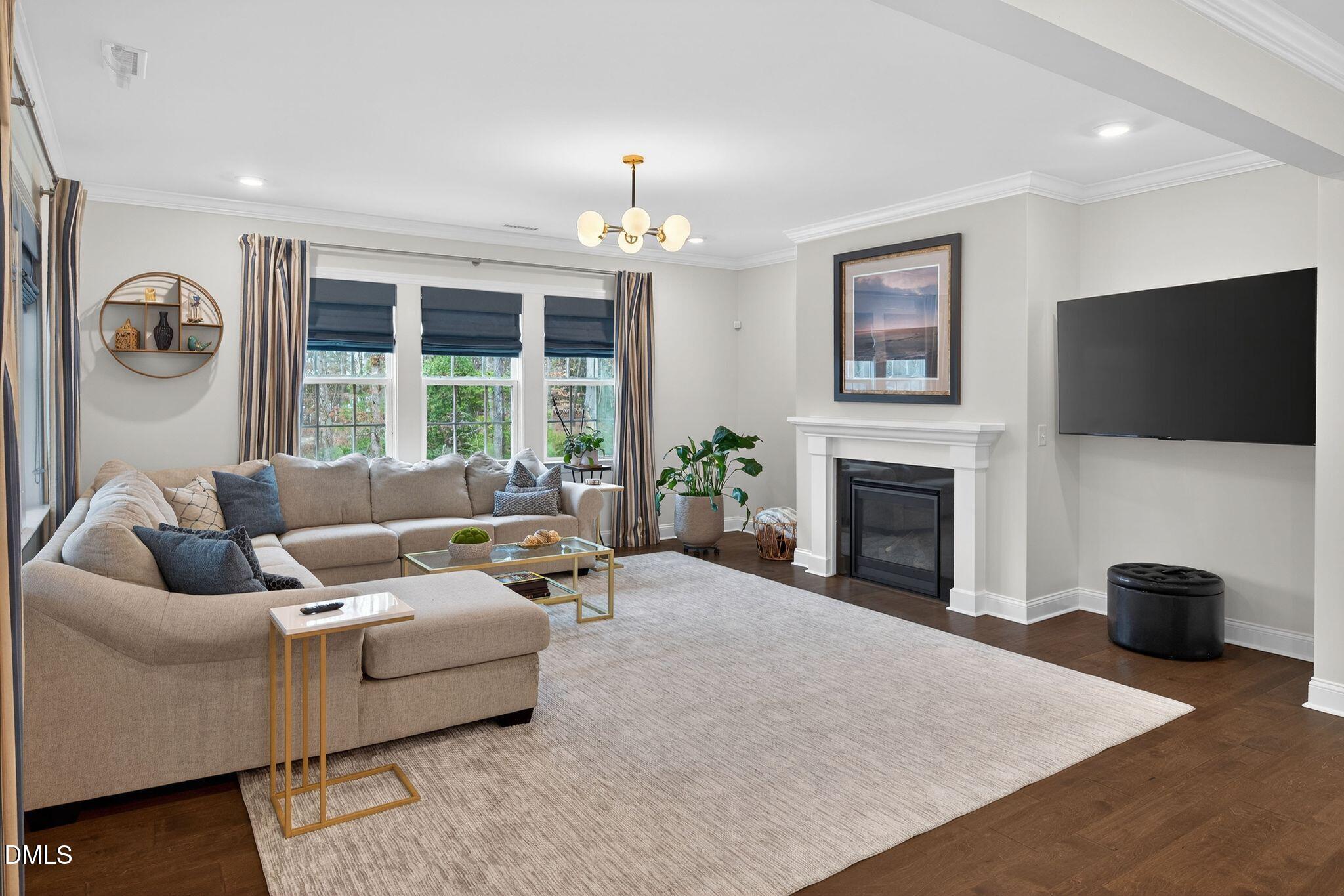 100 English Violet Lane Raleigh, NC 27610 - Photo 23 of 101 a living room with furniture a fireplace and a flat screen tv