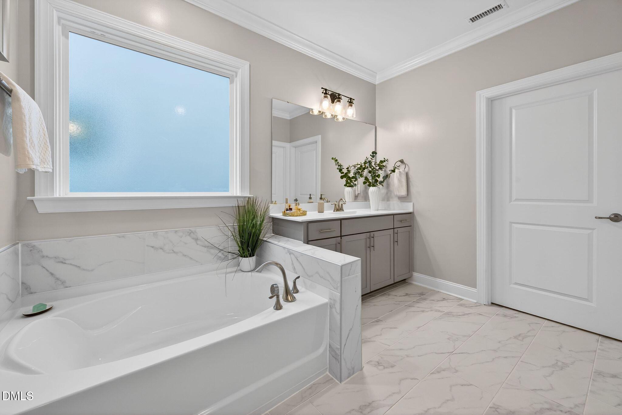 100 English Violet Lane Raleigh, NC 27610 - Photo 33 of 101 a bathroom with a bathtub and a sink
