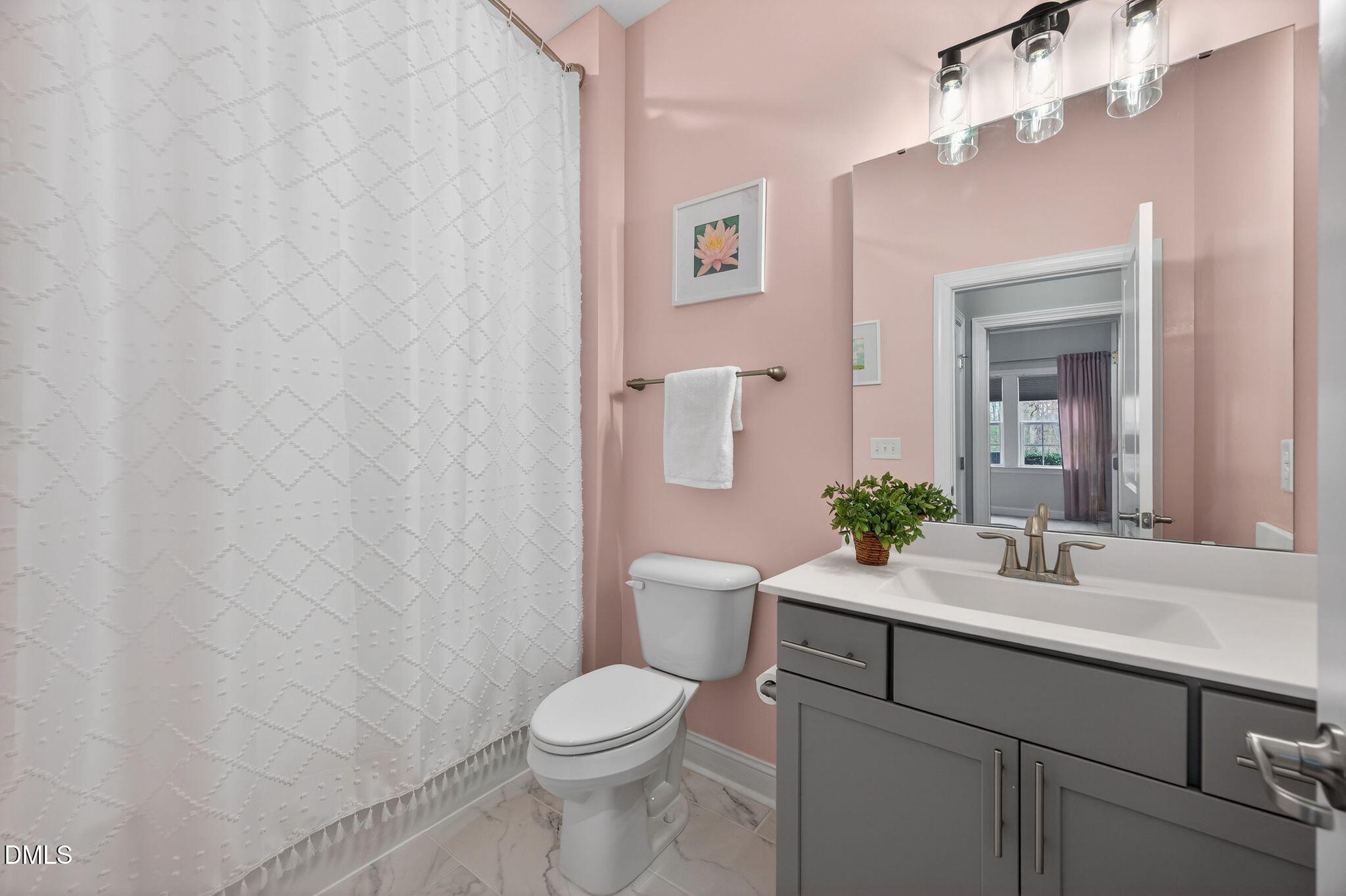 100 English Violet Lane Raleigh, NC 27610 - Photo 67 of 101 a bathroom with a sink a toilet and a mirror