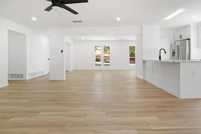 a view of a kitchen with a sink and wooden floor