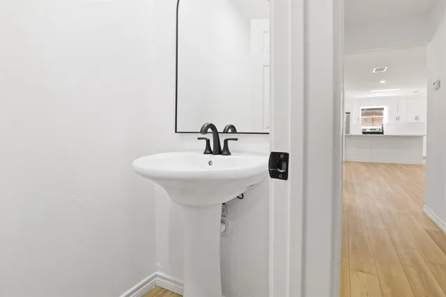 a view of a bedroom with wooden floor