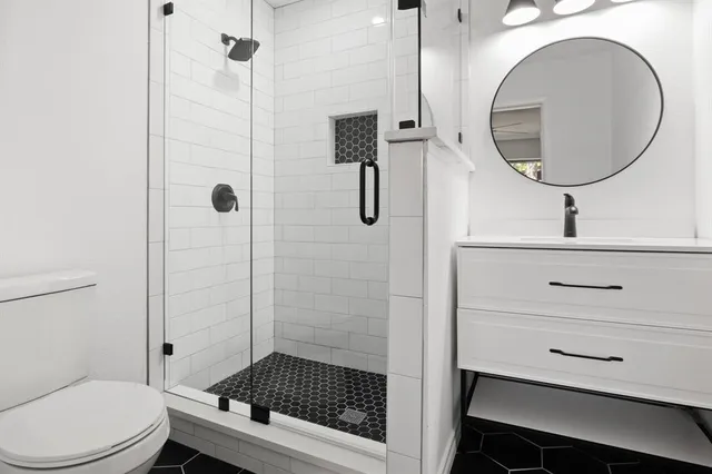 an empty room with chandelier fan