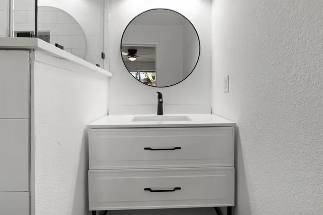 a bathroom with a sink a toilet and a mirror