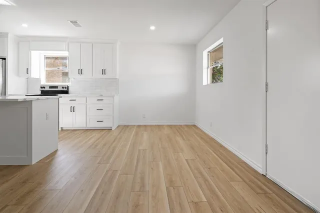 a view of a kitchen with wooden floor