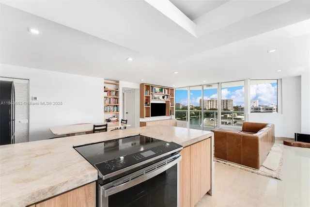 a kitchen with stainless steel appliances granite countertop a sink and a stove