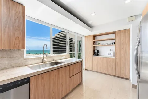 a kitchen with a sink and a refrigerator