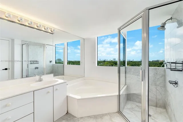 a spacious bathroom with a tub shower and windows