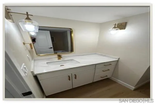 a bathroom with a sink vanity and mirror