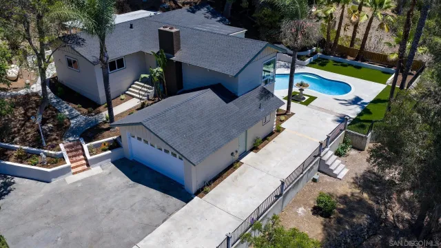 an aerial view of a house with garden space and street view