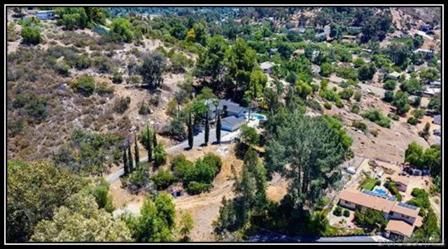 an aerial view of a houses with a yard