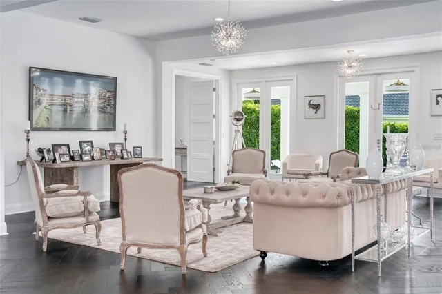 a kitchen with stainless steel appliances kitchen island a table chairs and a refrigerator