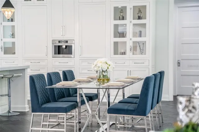 a living room with furniture a fireplace and kitchen view