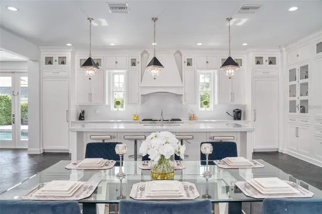 a kitchen with cabinets and chairs