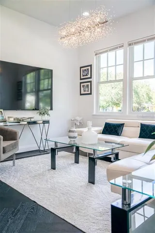 a bedroom with a bed and a chandelier