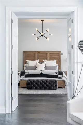 a bathroom with a tub sink double vanity and mirror