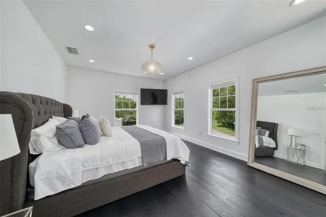 a living room with furniture a flat screen tv and a window