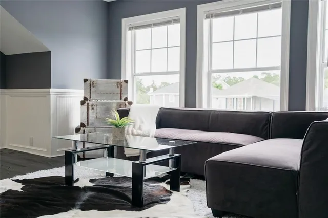 a view of a patio with couches table and chairs and potted plants