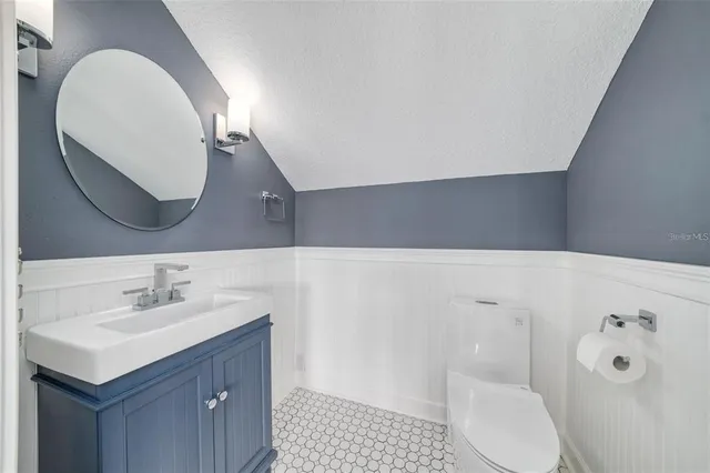 a view of swimming pool with lawn chairs and plants