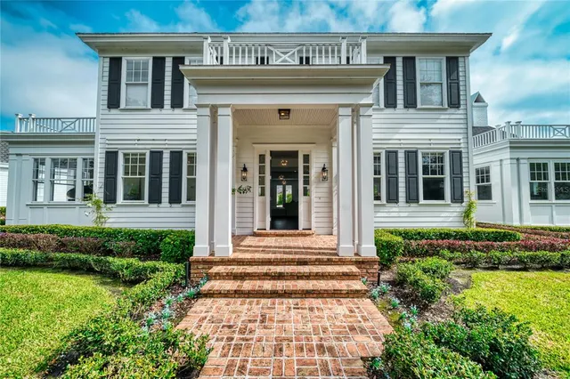 a view of a house with potted plants