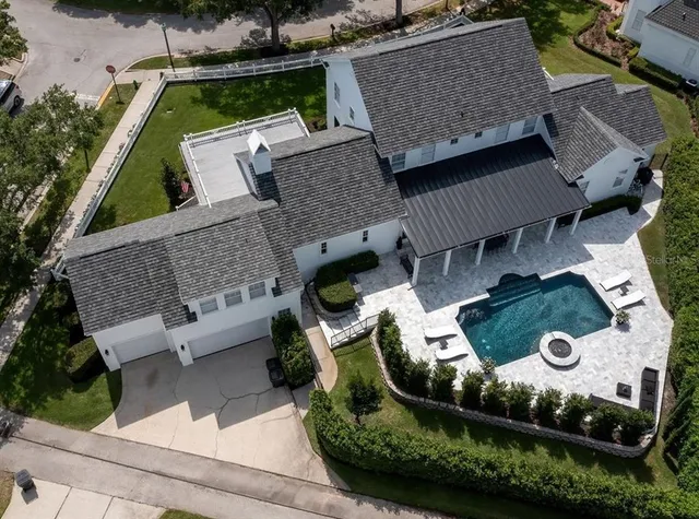an aerial view of a house with a garden and parking space