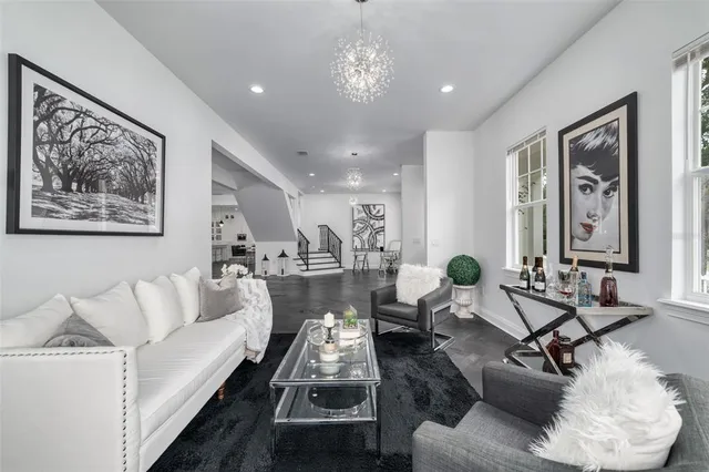 a living room with furniture and a chandelier